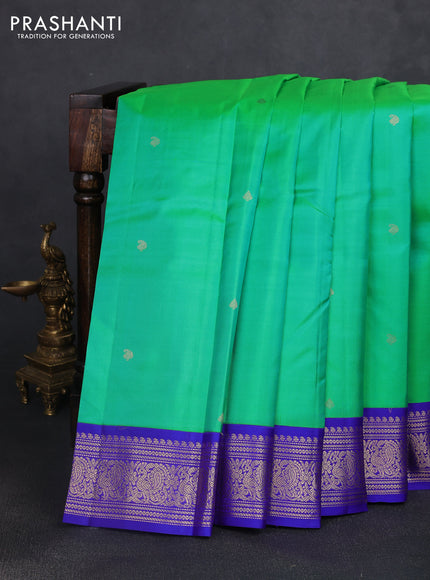 Pure kanchipuram silk saree dual shade of teal green and royal blue with zari woven buttas and rich zari woven korvai border