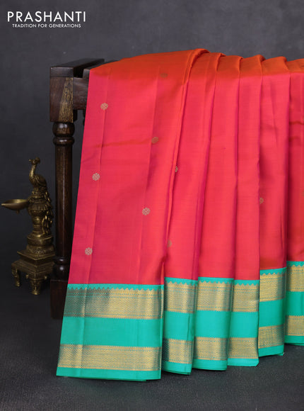 Pure kanchipuram silk saree dual shade of pinkish orange and teal blue with zari woven buttas and rettapet zari woven korvai border