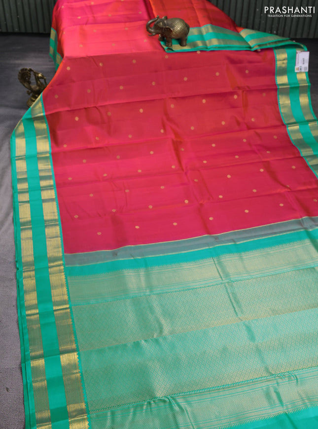 Pure kanchipuram silk saree dual shade of pinkish orange and teal blue with zari woven buttas and rettapet zari woven korvai border