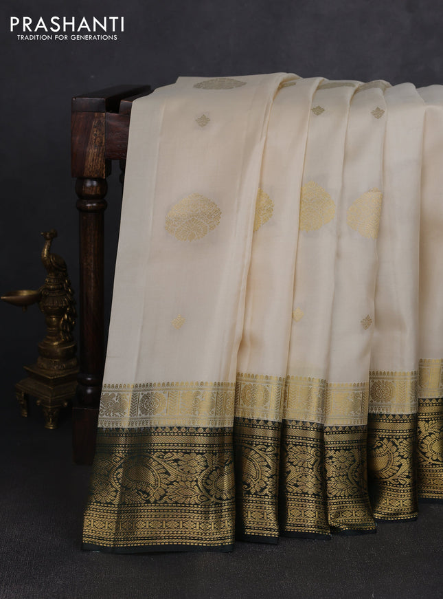 Pure kanchipuram silk saree cream and bottle green with zari woven buttas and long zari woven korvai border