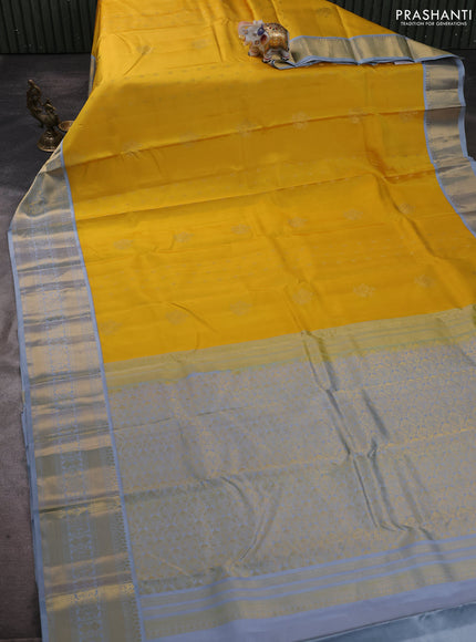 Pure kanchipuram silk saree yellow and grey with zari woven buttas and zari woven korvai border