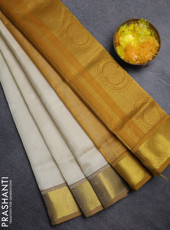 Silk cotton saree cream and mustard yellow with allover self emboss jacquard pattern and annam zari woven border