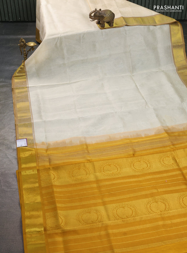 Silk cotton saree cream and mustard yellow with allover self emboss jacquard pattern and annam zari woven border