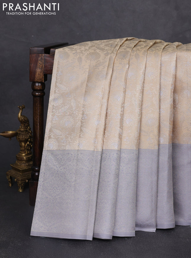 Pure kanchipuram silk saree beige and grey with allover floral self emboss pattern and long rich zari woven border