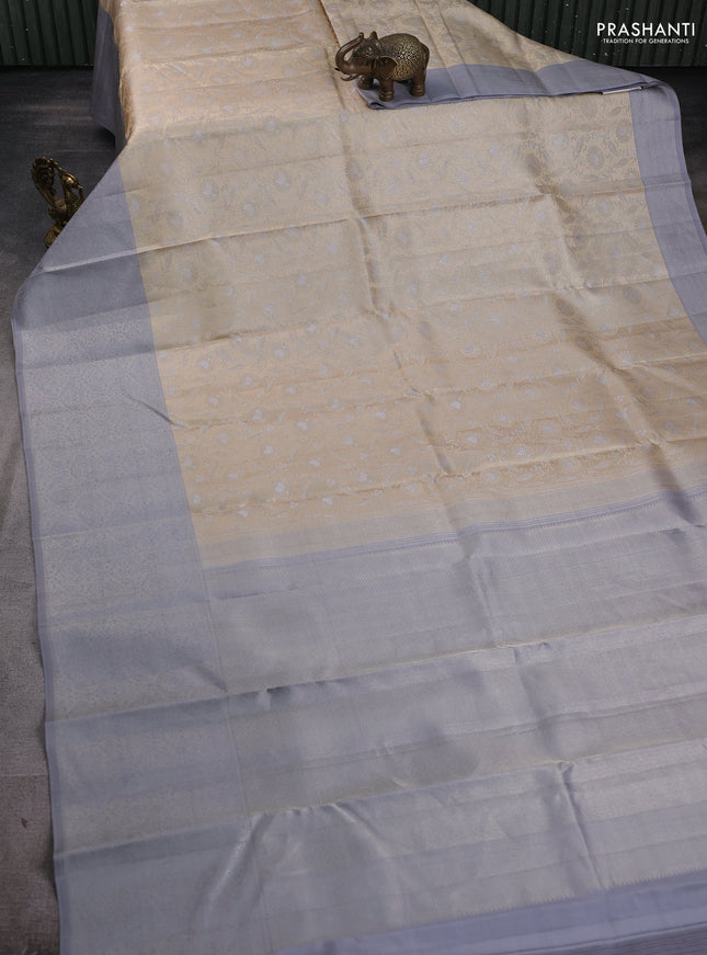 Pure kanchipuram silk saree beige and grey with allover floral self emboss pattern and long rich zari woven border