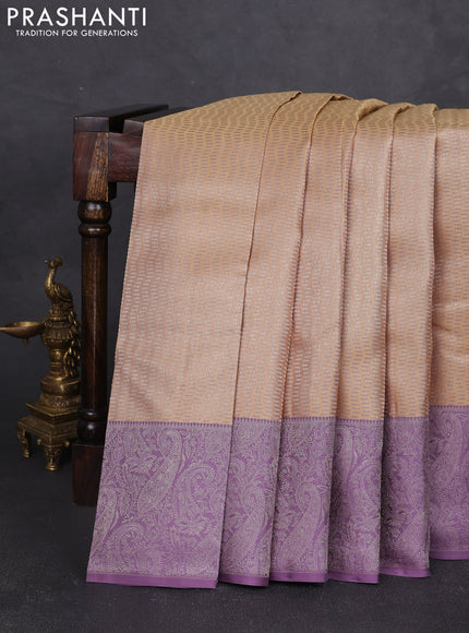 Pure kanchipuram silk saree beige and pastel purple with allover self emboss pattern and rich paisley zari woven border
