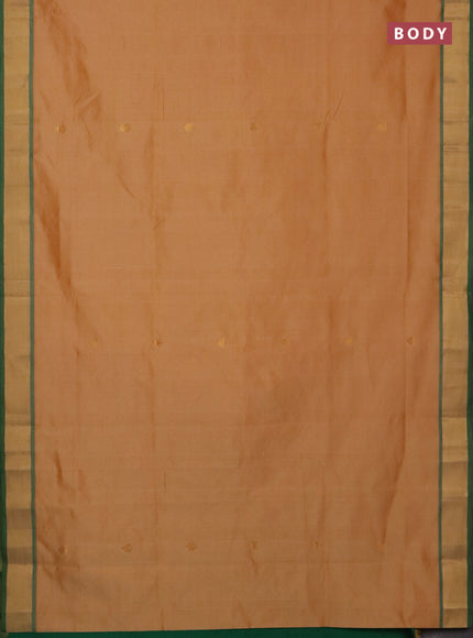 Semi silk cotton saree pale orange and green with allover zari woven buttas and zari woven border