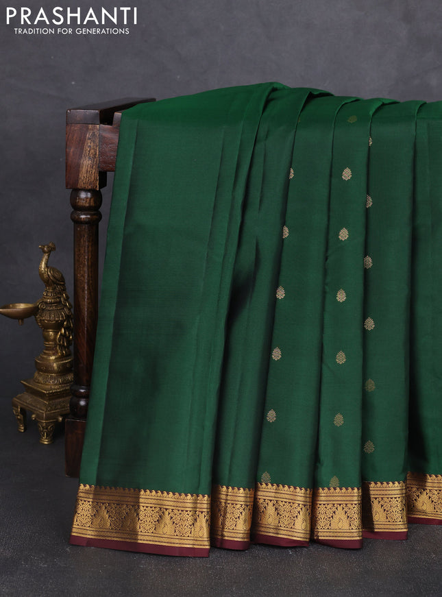Pure kanchipram silk saree bottle green and wine shade with allover zari woven buttas and zari woven border