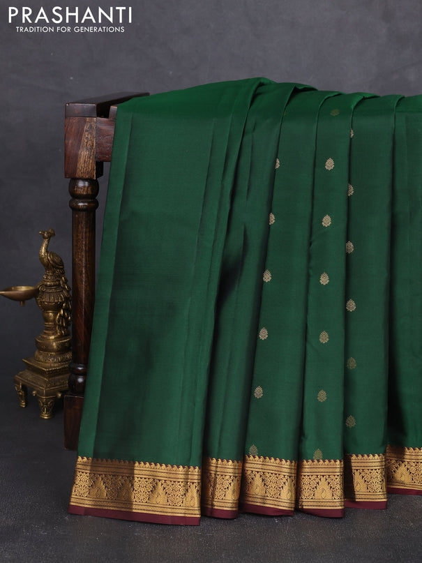 Pure kanchipram silk saree bottle green and wine shade with allover zari woven buttas and zari woven border