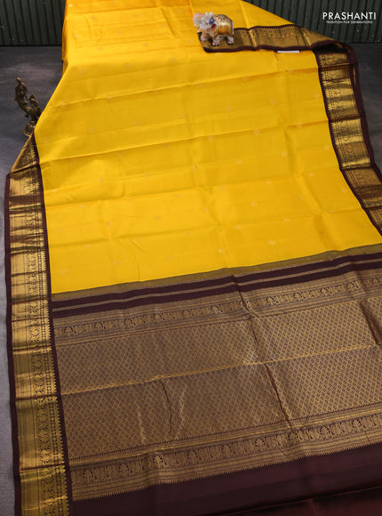 Pure kanchipram silk saree yellow and coffee brown with zari woven buttas and zari woven korvai border