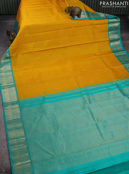 Pure kanchipram silk saree yellow and teal green with zari woven buttas and zari woven korvai border