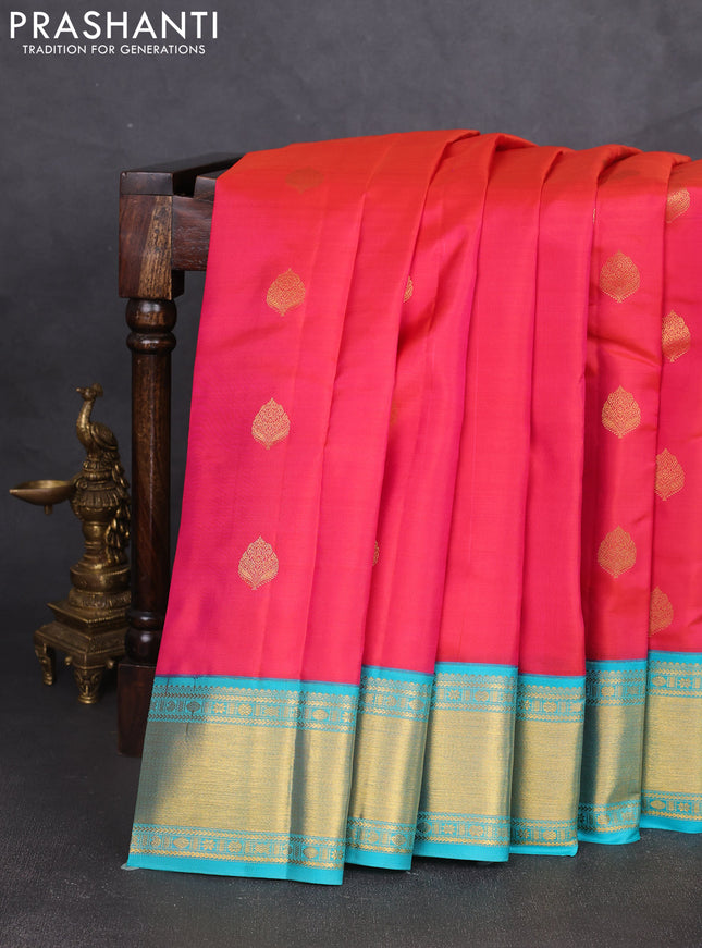 Pure kanchipram silk saree dual shade of pinkish orange and teal blue with zari woven buttas and zari woven korvai border