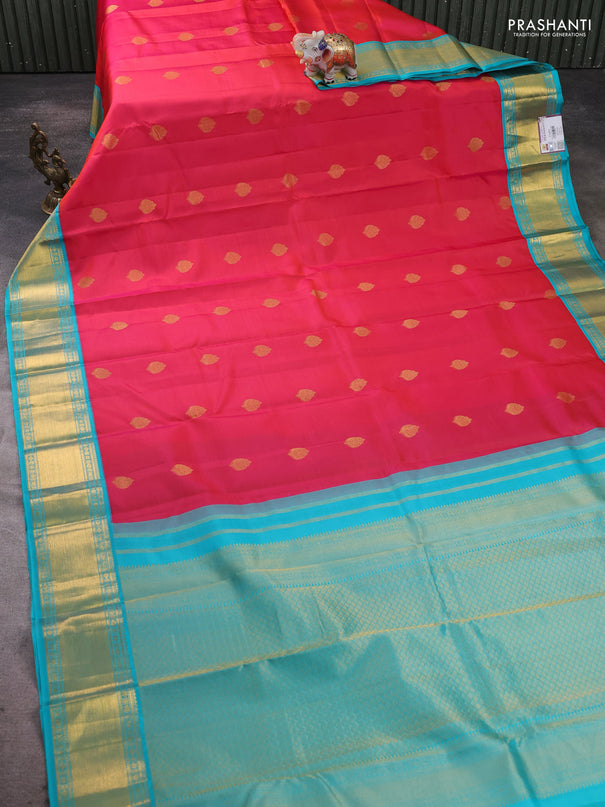 Pure kanchipram silk saree dual shade of pinkish orange and teal blue with zari woven buttas and zari woven korvai border