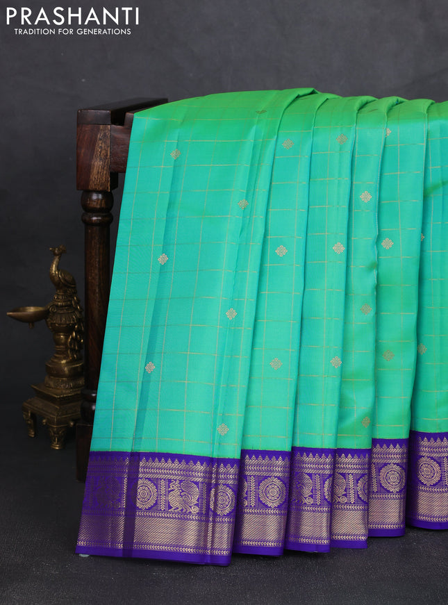 Pure kanchipram silk saree dual shade of teal green and blue with allover zari checks & buttas and zari woven korvai border