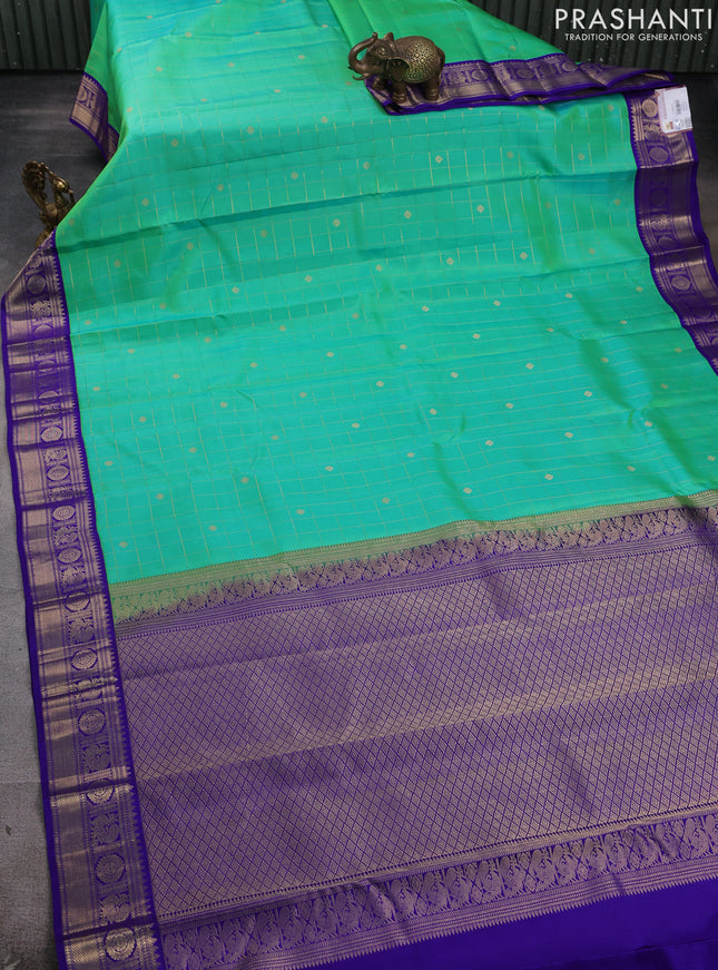 Pure kanchipram silk saree dual shade of teal green and blue with allover zari checks & buttas and zari woven korvai border