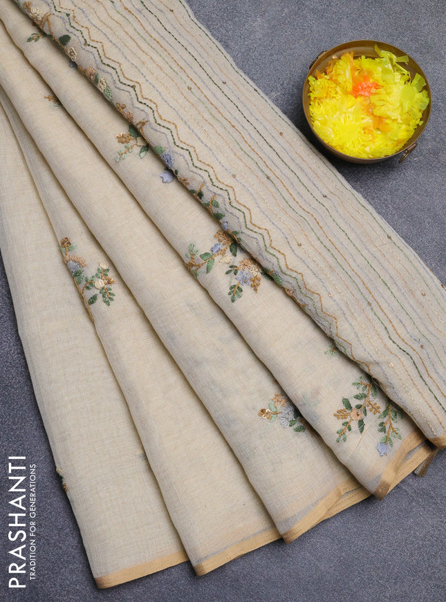 Linen cotton saree beige with embroidery buttas and zari woven border