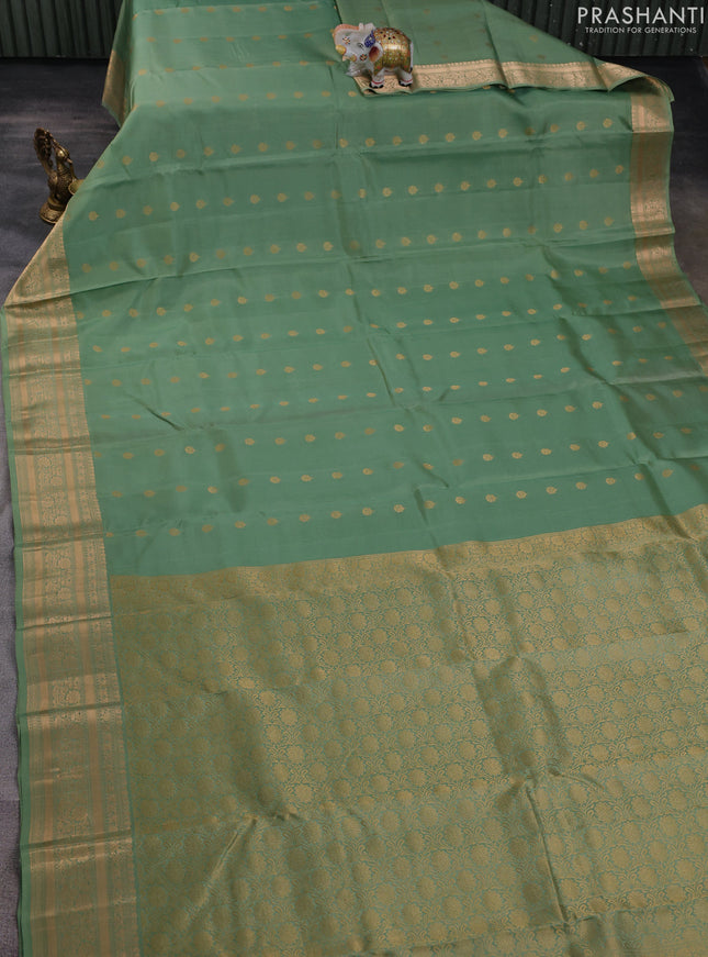 Kanchipuram silk saree pastel green with allover zari woven buttas and zari woven border