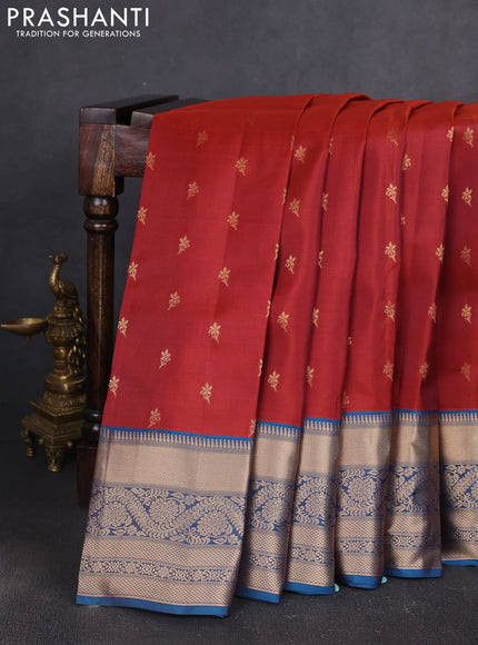 Kanchipuram silk saree rustic orange and peacock blue with allover zari woven buttas and long zari woven border