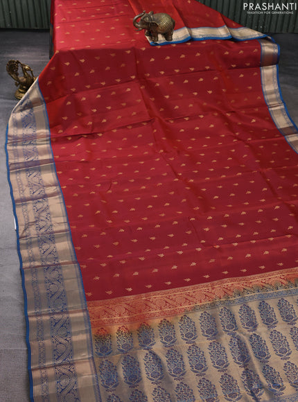 Kanchipuram silk saree rustic orange and peacock blue with allover zari woven buttas and long zari woven border