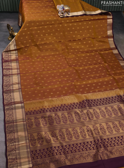 Kanchipuram silk saree dark mustard and wine shade with allover zari woven buttas and rich zari woven border