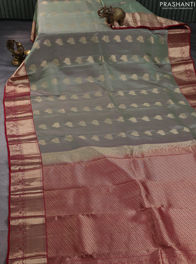 Kanchipuram silk saree dual shade of green shade and maroon with allover zari woven buttas and zari woven border