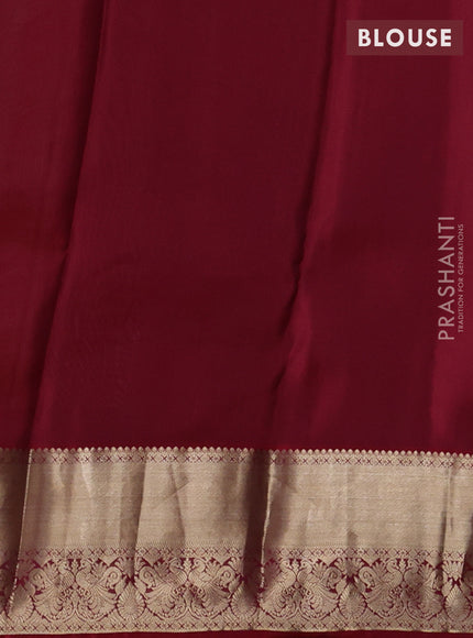 Kanchipuram silk saree dual shade of green shade and maroon with allover zari woven buttas and zari woven border