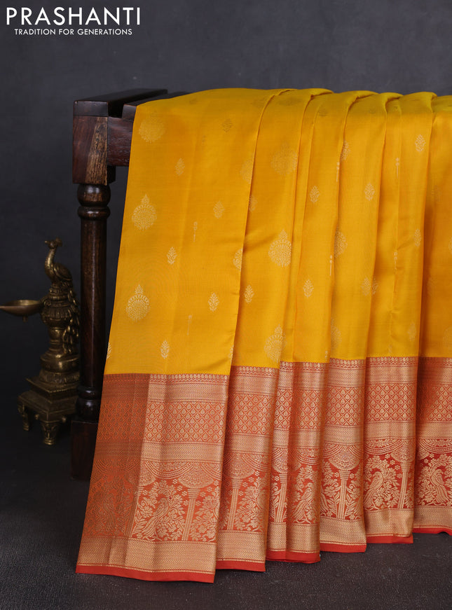 Kanchipuram silk saree yellow and rust shade with allover zari woven buttas and long zari woven border