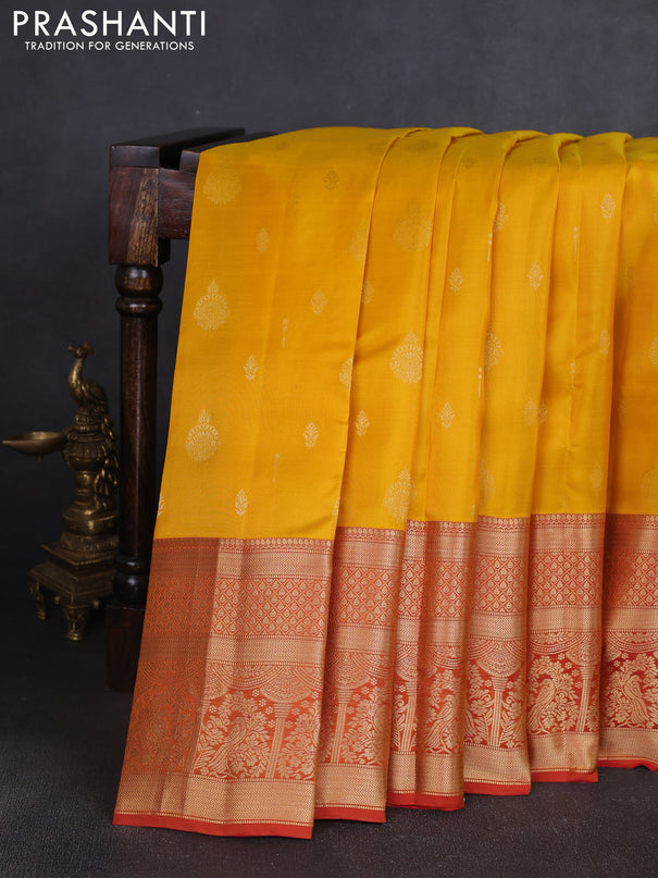 Kanchipuram silk saree yellow and rust shade with allover zari woven buttas and long zari woven border