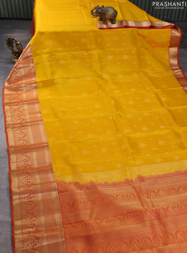 Kanchipuram silk saree yellow and rust shade with allover zari woven buttas and long zari woven border