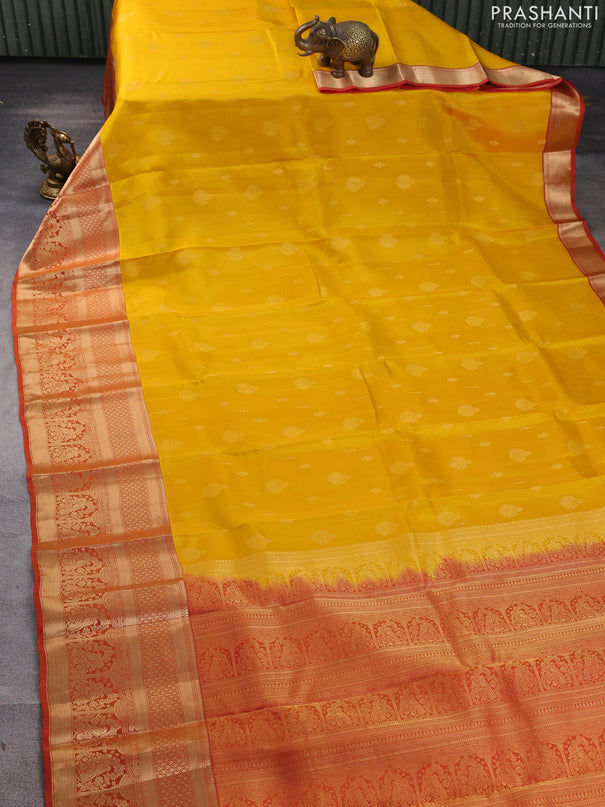 Kanchipuram silk saree yellow and rust shade with allover zari woven buttas and long zari woven border