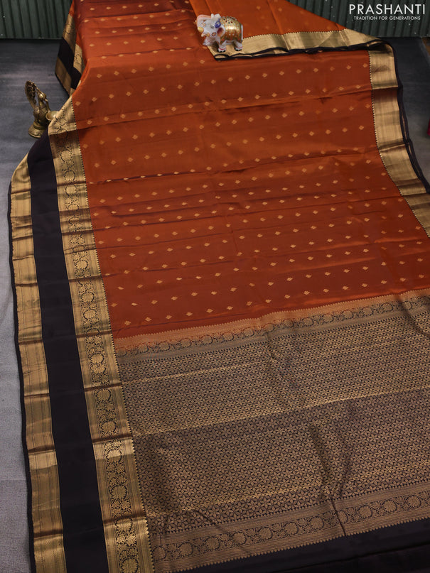 Kanchipuram silk saree rustic orange and black with allover zari woven buttas and long rettapet zari woven border
