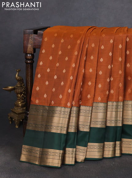 Kanchipuram silk saree rust shade and bottle green with allover zari woven buttas and long rettapet zari woven border
