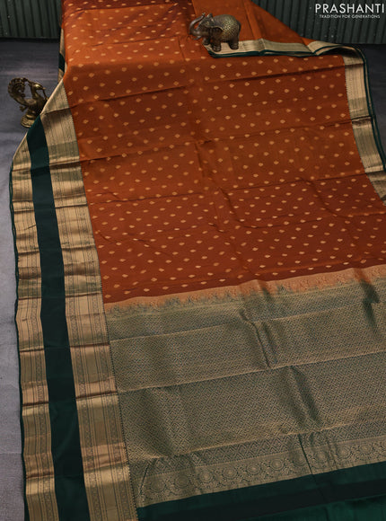 Kanchipuram silk saree rust shade and bottle green with allover zari woven buttas and long rettapet zari woven border
