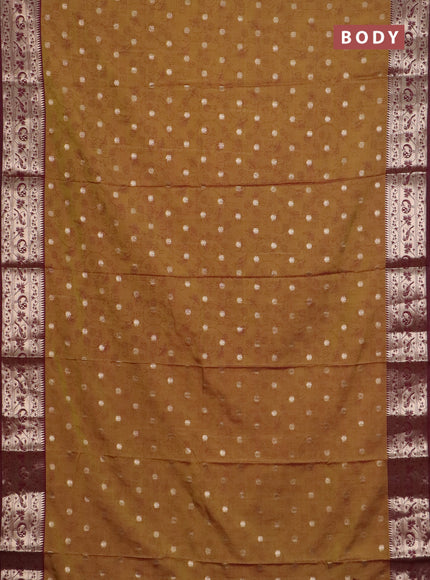 Semi raw silk saree dual shade of dark mustard green and wine shade with allover prints & 1000 zari buttas and zari woven border