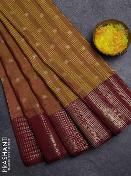 Semi raw silk saree dual shade of dark mustard green and wine shade with allover kalamkari prints & 1000 zari buttas and zari checked butta border