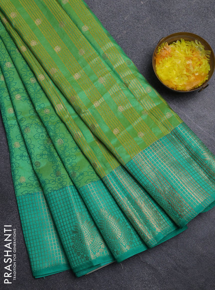 Semi raw silk saree dual shade of light green and teal green with allover kalamkari prints & 1000 zari buttas and zari checked butta border