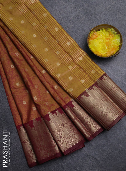 Semi raw silk saree dual shade of dark mustard and maroon with allover kalamkari prints & 1000 zari buttas and temple design zari woven border