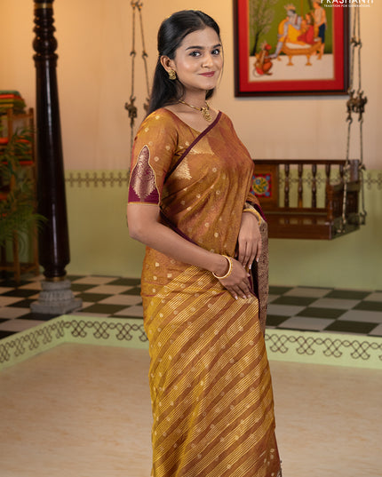 Semi raw silk saree dual shade of dark mustard and wine shade with allover floral butta prints & 1000 zari buttas and zari woven border