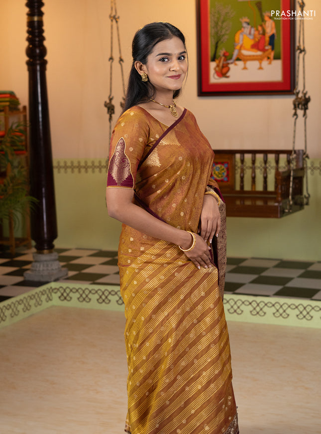 Semi raw silk saree dual shade of dark mustard and wine shade with allover floral butta prints & 1000 zari buttas and zari woven border
