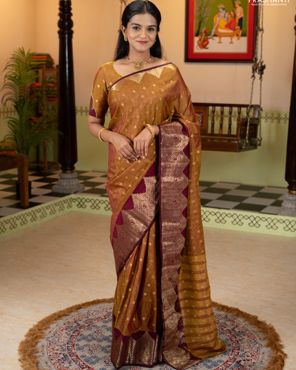 Semi raw silk saree dual shade of dark mustard and wine shade with allover floral butta prints & 1000 zari buttas and zari woven border