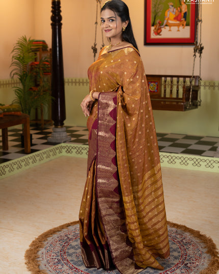 Semi raw silk saree dual shade of dark mustard and wine shade with allover floral butta prints & 1000 zari buttas and zari woven border
