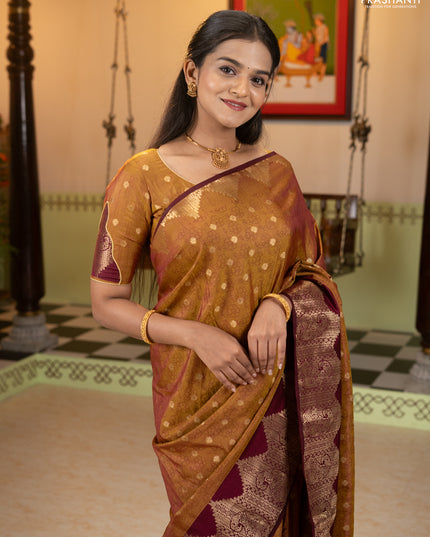 Semi raw silk saree dual shade of dark mustard and wine shade with allover floral butta prints & 1000 zari buttas and zari woven border