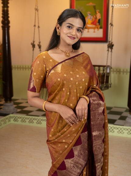 Semi raw silk saree dual shade of dark mustard and wine shade with allover floral butta prints & 1000 zari buttas and zari woven border