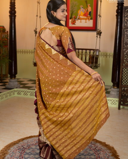Semi raw silk saree dual shade of dark mustard and wine shade with allover floral butta prints & 1000 zari buttas and zari woven border