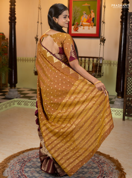 Semi raw silk saree dual shade of dark mustard and wine shade with allover floral butta prints & 1000 zari buttas and zari woven border
