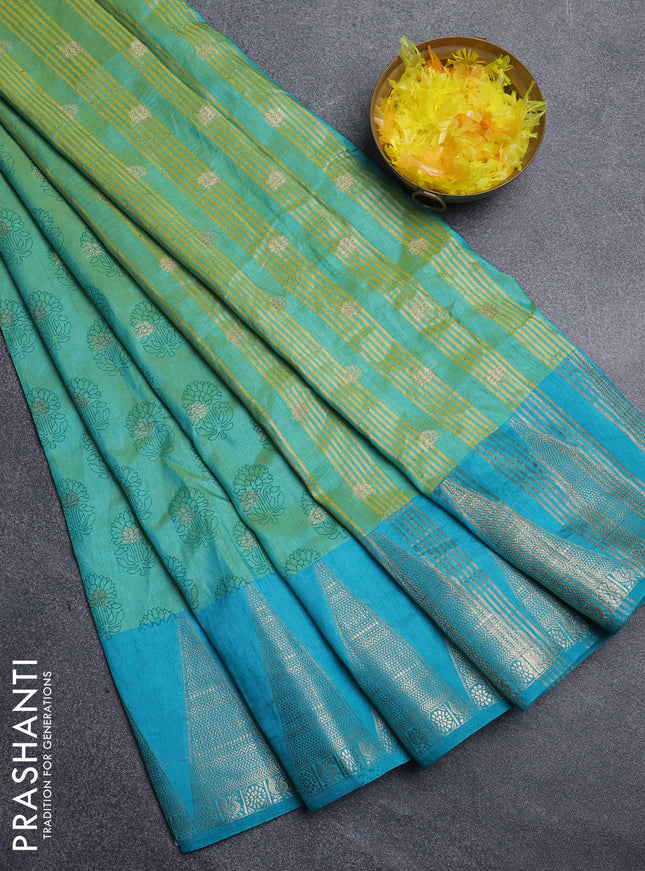 Semi raw silk saree dual shade of teal blue and cs blue with allover floral butta prints & 1000 zari buttas and temple design zari woven border