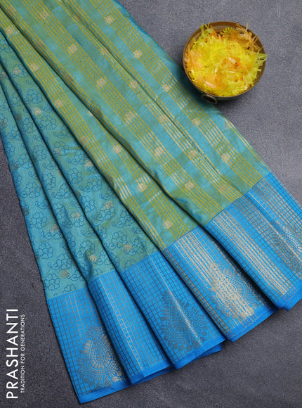 Semi raw silk saree dual shade of teal bluish green and cs blue with allover floral prints & 1000 zari buttas and long zari woven border