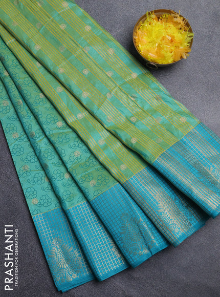 Semi raw silk saree dual shade of teal bluish green and teal blue with allover floral prints & 1000 zari buttas and long zari woven border