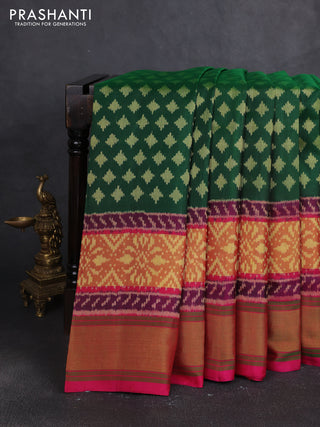 Rajkot patola silk saree bottle green and magenta pink with allover ikat woven buttas and zari woven border