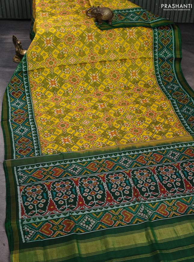 Rajkot patola silk saree yellow and green with allover ikat weaves and ikat woven simple border